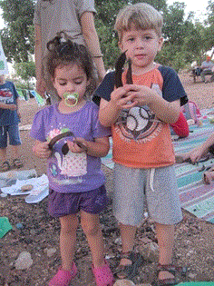 Children show the carob they harvested