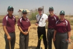 Group of airforce cadets with a freshly planted tree.
